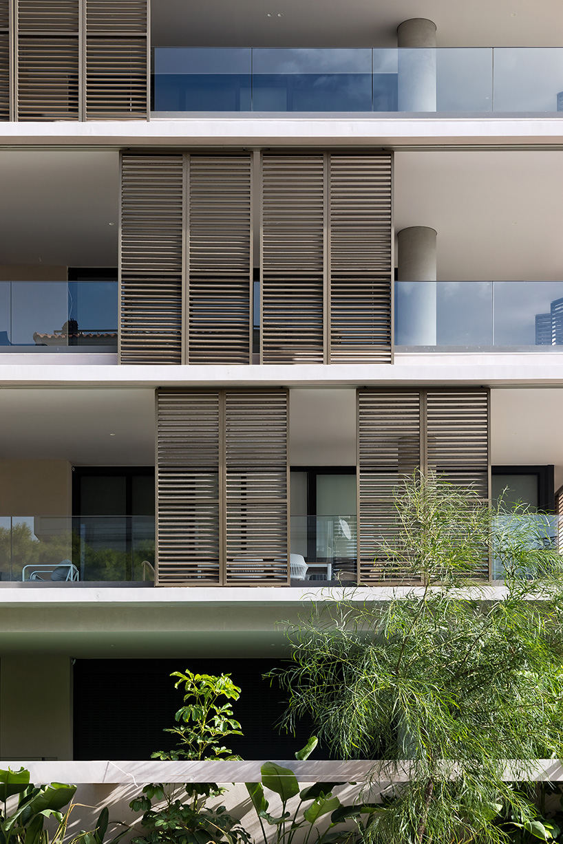glass panes interlock between concrete slabs residential development in athens' suburbs