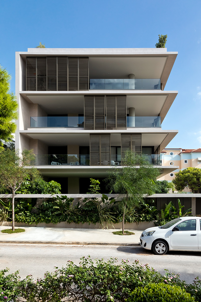 glass panes interlock between concrete slabs residential development in athens' suburbs