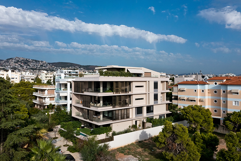glass panes interlock between concrete slabs residential development in athens' suburbs