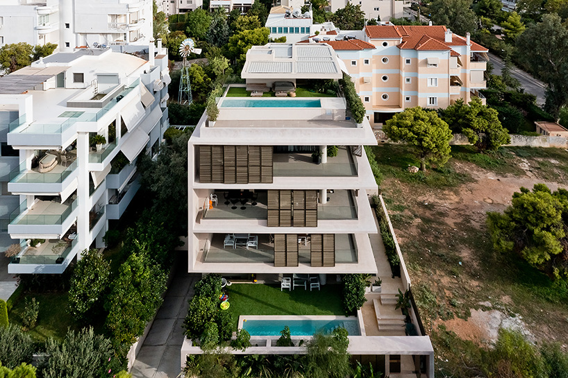 glass panes interlock between concrete slabs residential development in athens' suburbs