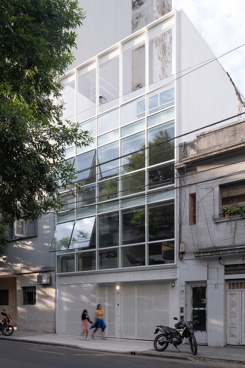 moreno 2681's transparent glass facade reflects buenos aires' cityscape