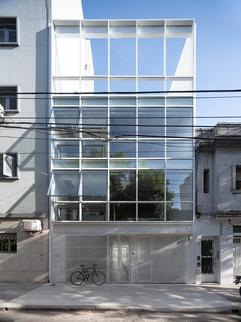 moreno 2681's transparent glass facade reflects buenos aires' cityscape
