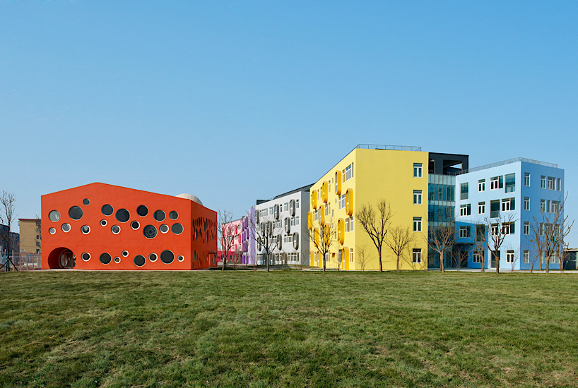 Twelve colorful bridges hang over the atrium of the Zickzack primary school by SAKO architects