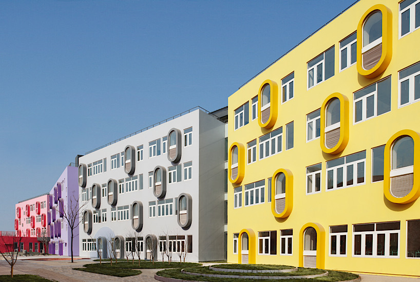 Twelve colorful bridges hang over the atrium of the Zickzack primary school by SAKO architects