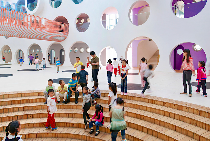 Twelve colorful bridges hang over the atrium of the Zickzack primary school by SAKO architects