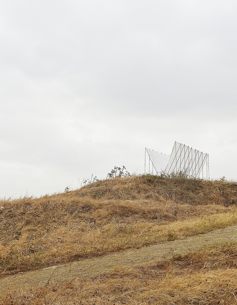 translucent fabric binds horizon pavilion's arrayed metal frame atop of ecuador hillside