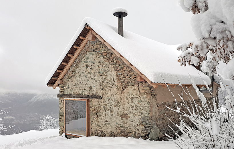 officina82 employs wood and stone to renovate abandoned rye barn in the italian alps