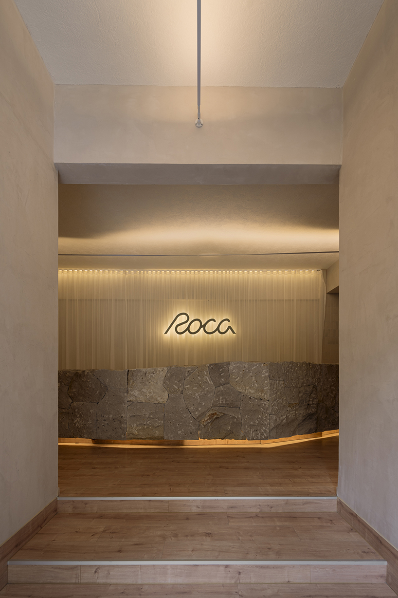 granite and fabric shape an interplay of solidity and fluidity at roca pilates studio in mexico