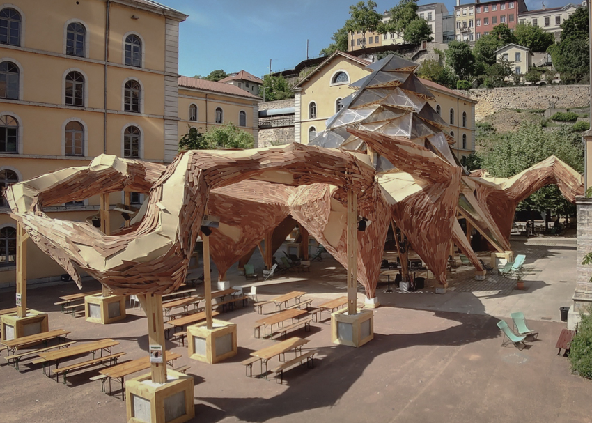 kraken installation made of reclaimed wood spreads its tentacles in lyon