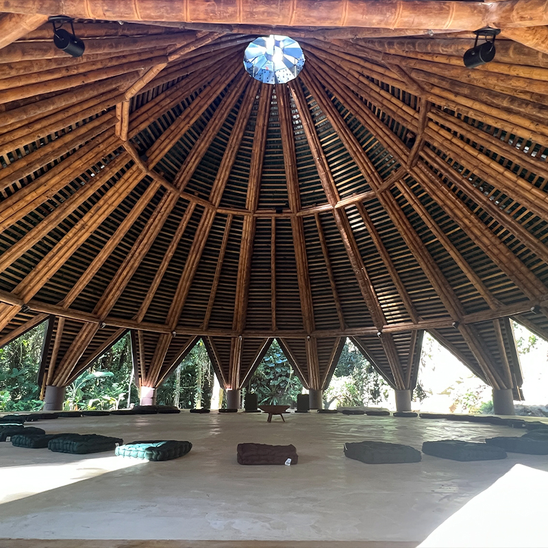ceramic tiles in blue and green hues cover tapered ayuru forest temple in brazil
