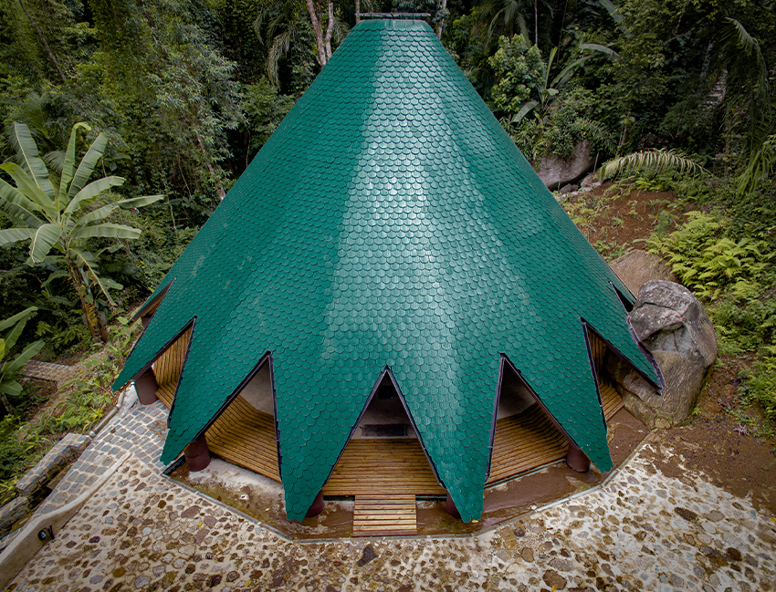 ceramic tiles in blue and green hues cover tapered ayuru forest temple in brazil