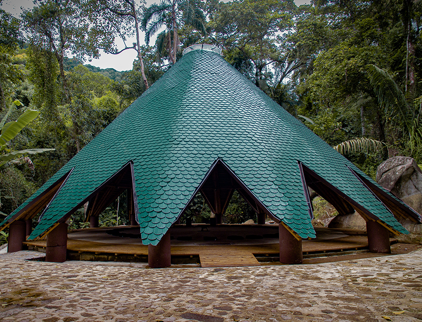 ceramic tiles in blue and green hues cover tapered ayuru forest temple in brazil