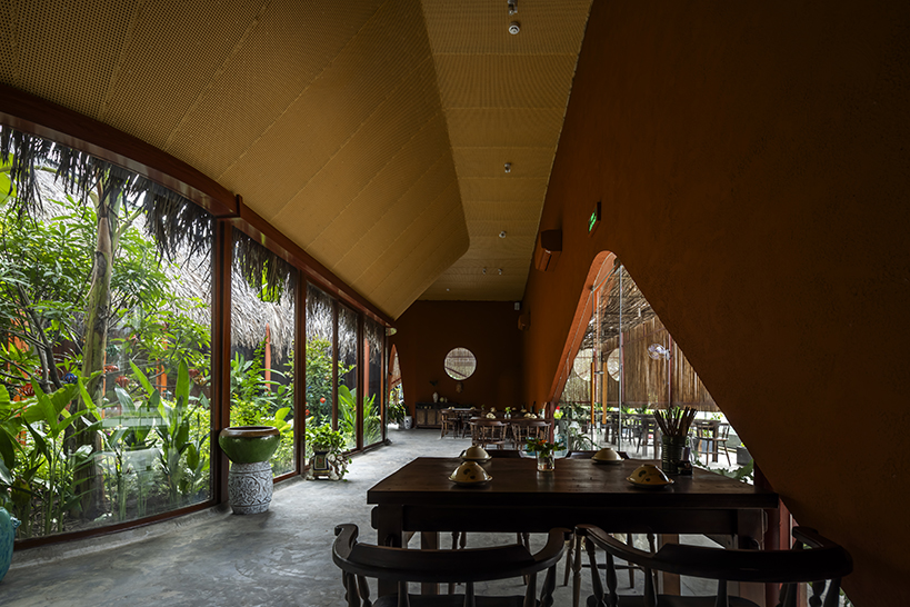 bamboo skin shades over nhà tú garden restaurant's outer dining space in vietnam