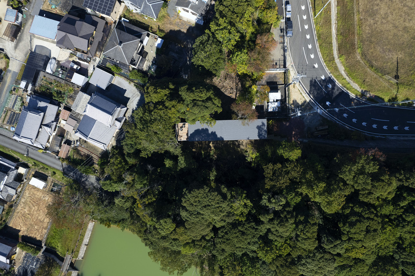 OHArchitecture embeds stepped camma villa and office onto sloping site in otsu, japan