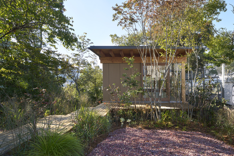 OHArchitecture embeds stepped camma villa and office onto sloping site in otsu, japan