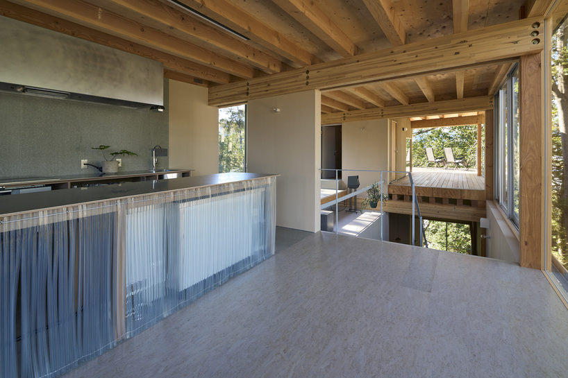 OHArchitecture embeds stepped camma villa and office onto sloping site in otsu, japan