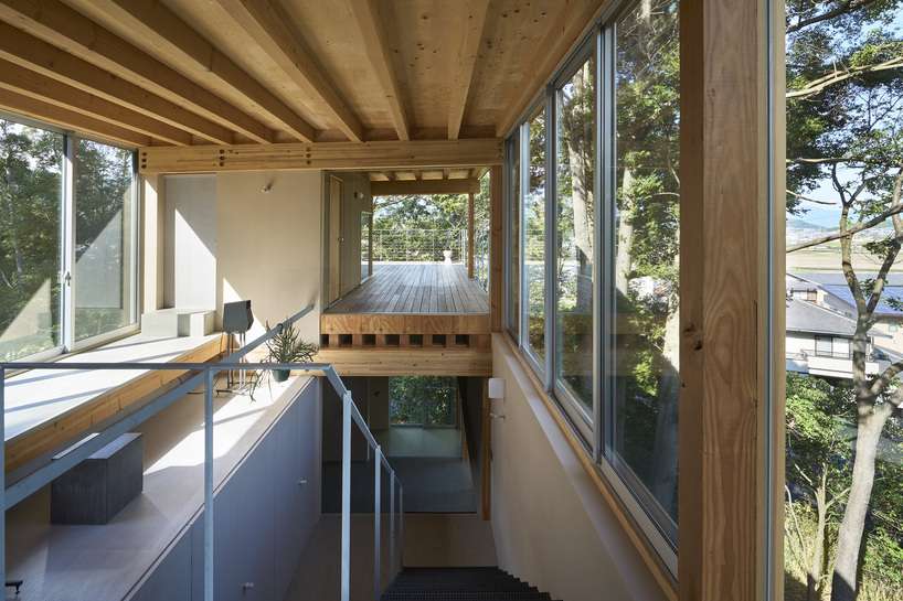 OHArchitecture embeds stepped camma villa and office onto sloping site in otsu, japan