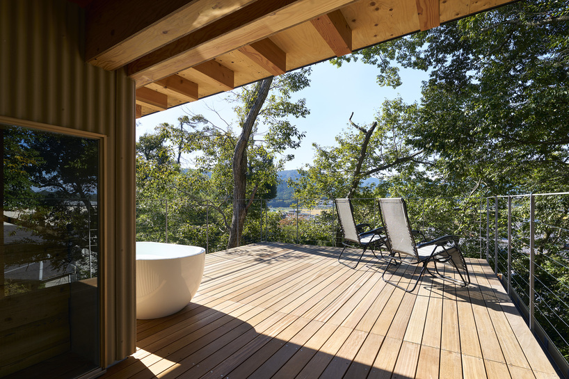 OHArchitecture embeds stepped camma villa and office onto sloping site in otsu, japan