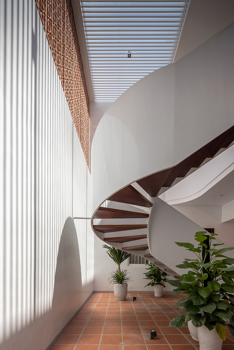 perforated double-skin brick facade shields grand house in vietnam