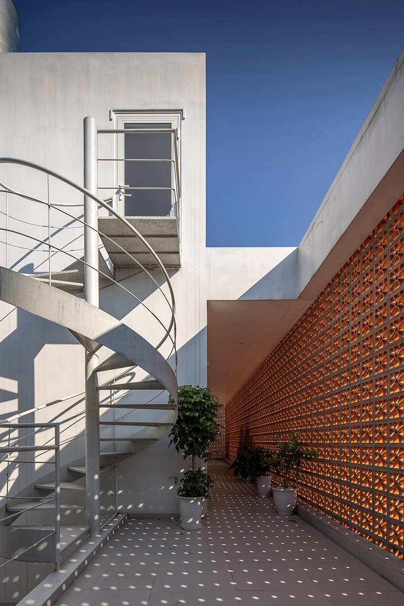 perforated double-skin brick facade shields grand house in vietnam