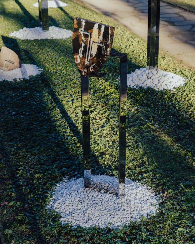 berenice curt sculpts androgynous faces into reclaimed marble at milan design week