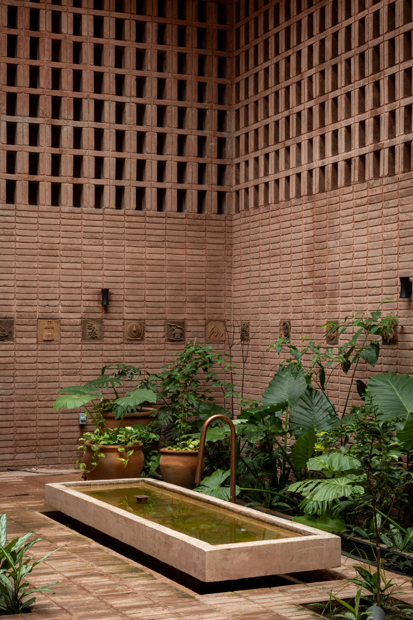 cast in red-pigmented concrete, la cacaotera museum celebrates cacao heritage in mexico - 7