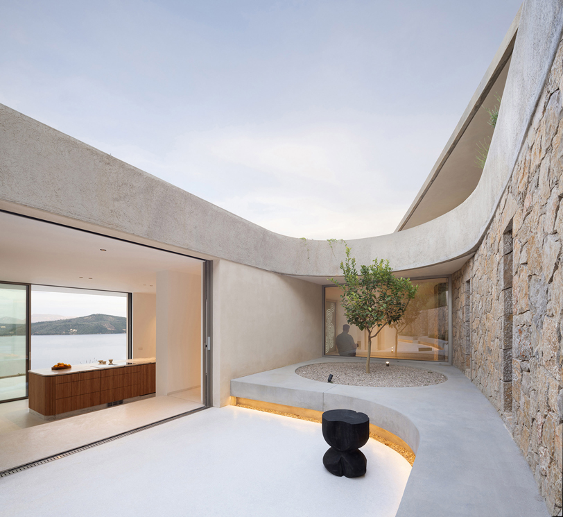 thyta house's curvilinear silhouettes run along the mountainous landscape of lefkada, greece