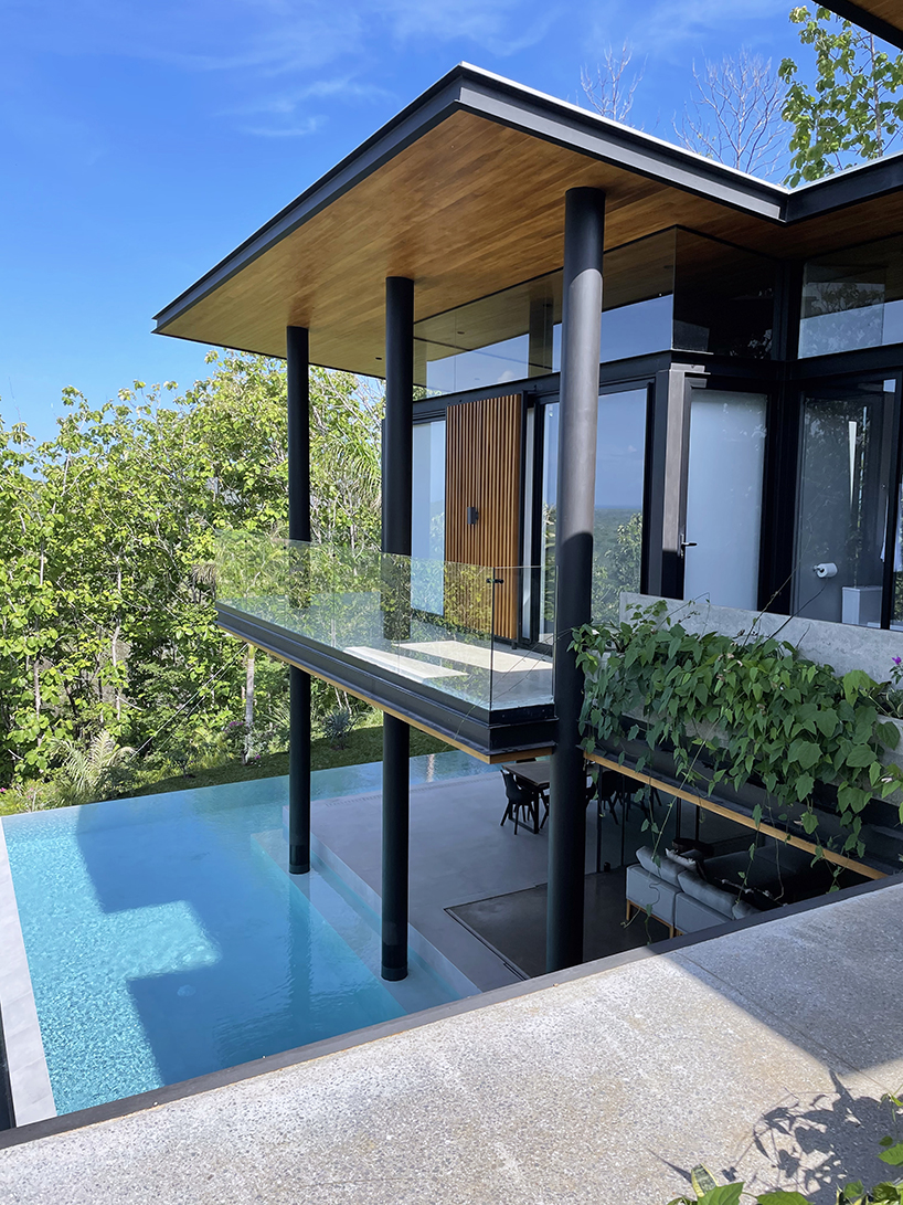 concrete residence's L-shaped infinity pool merges with costa rica's pacific coast