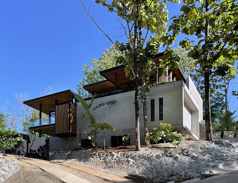 concrete residence's L-shaped infinity pool merges with costa rica's pacific coast