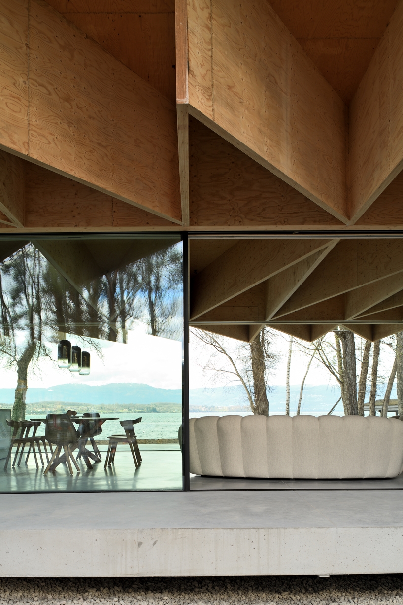 Paneles de madera tipo origami se despliegan sobre la casa Bachholz en el lago de Ginebra