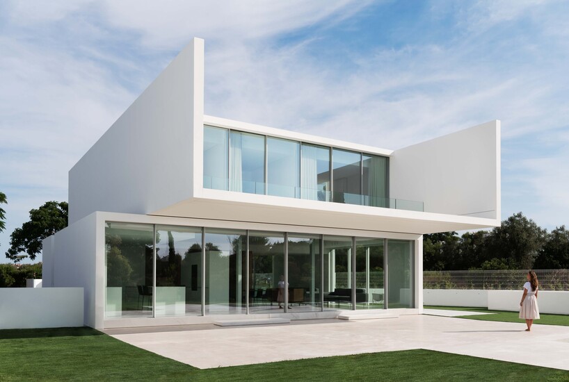 ruben muedra arquitectura's wisdom house stacks two white glazed prisms ...