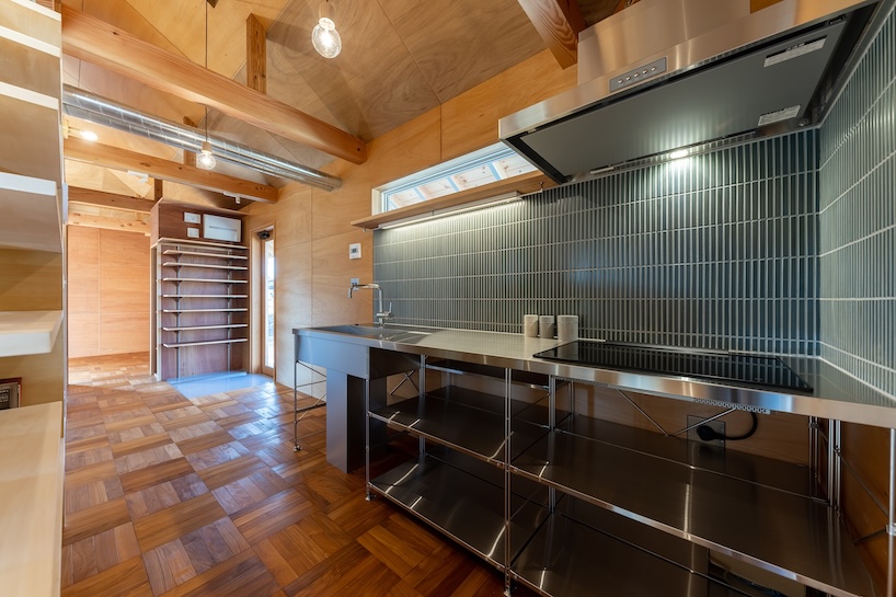 wooden house by architrip extends fluily into surrounding garden in japan