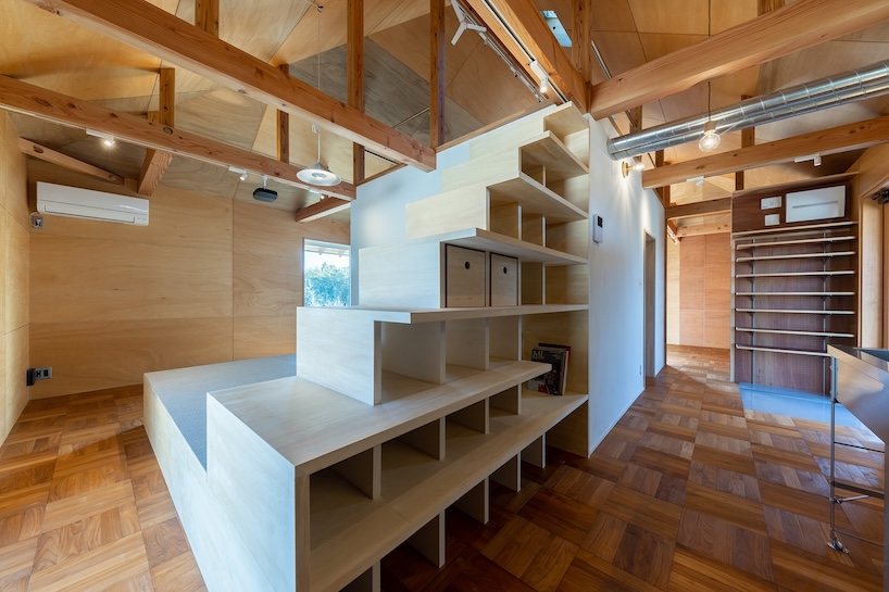 wooden house by architrip extends fluily into surrounding garden in japan