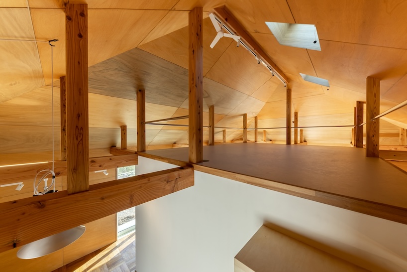 wooden house by architrip extends fluily into surrounding garden in japan