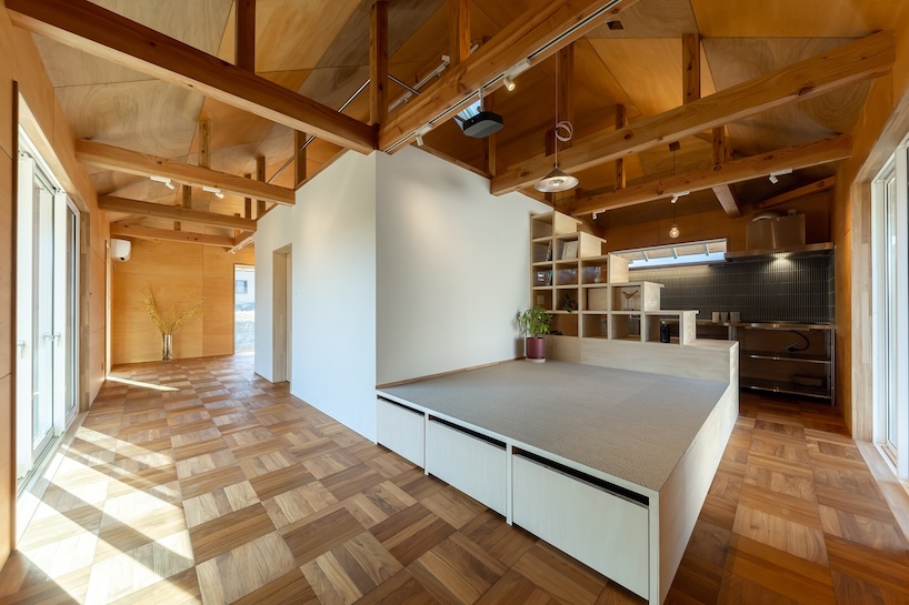 wooden house by architrip extends fluily into surrounding garden in japan