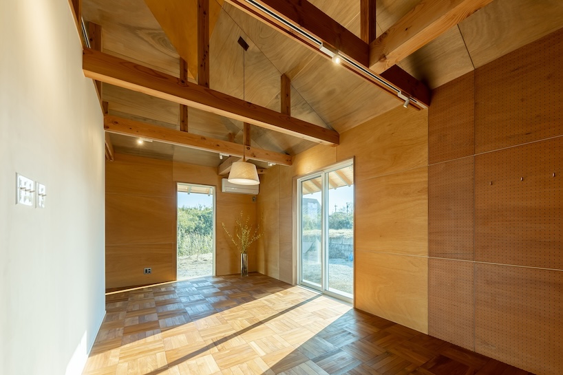 wooden house by architrip extends fluily into surrounding garden in japan