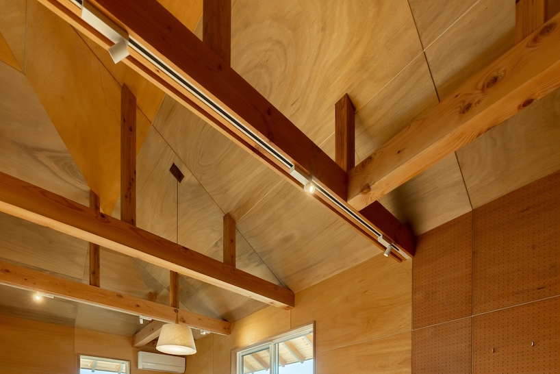 wooden house by architrip extends fluily into surrounding garden in japan