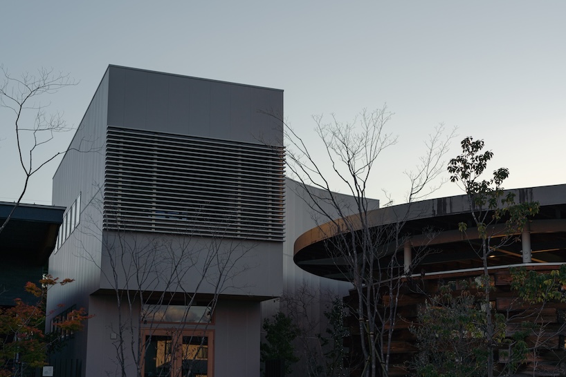 architrip's retail space curves between two existing shops in fukushima