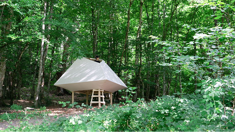 meaningless architecture's meditation cabin lights up like a lantern in french woodlands