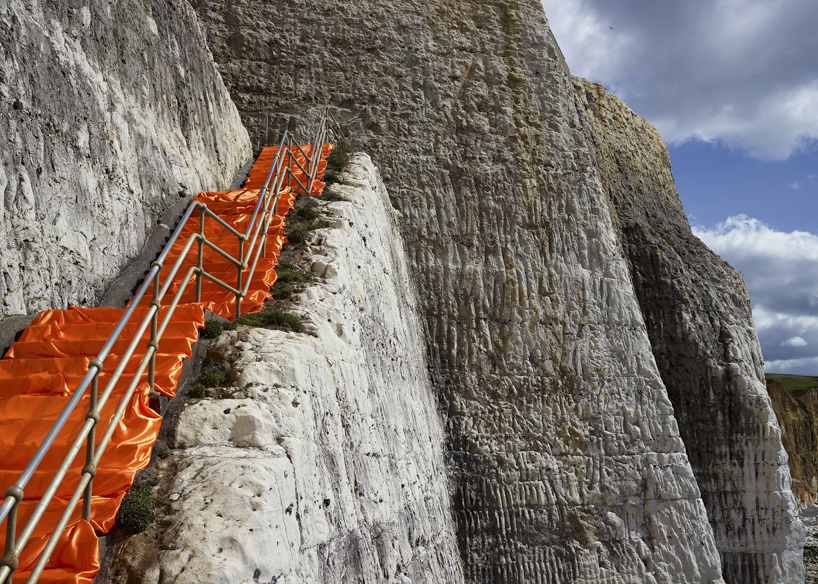 vibrant fabrics drape over chalk cliffs highlighting rock erosion of coastal landscapes