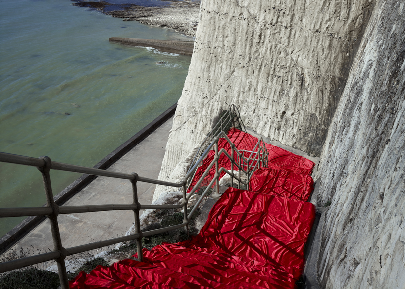 vibrant fabrics drape over chalk cliffs highlighting rock erosion of coastal landscapes