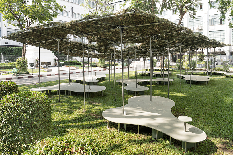people pavilion's decomposed grass canopy shades over free-form circular seating