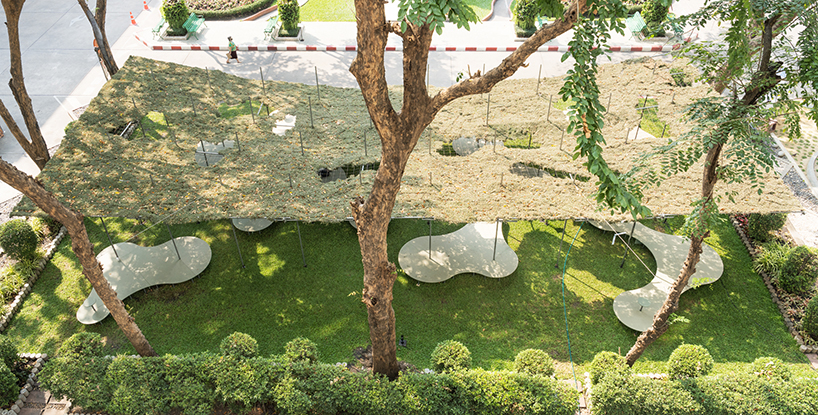 people pavilion's decomposed grass canopy shades over free-form circular seating