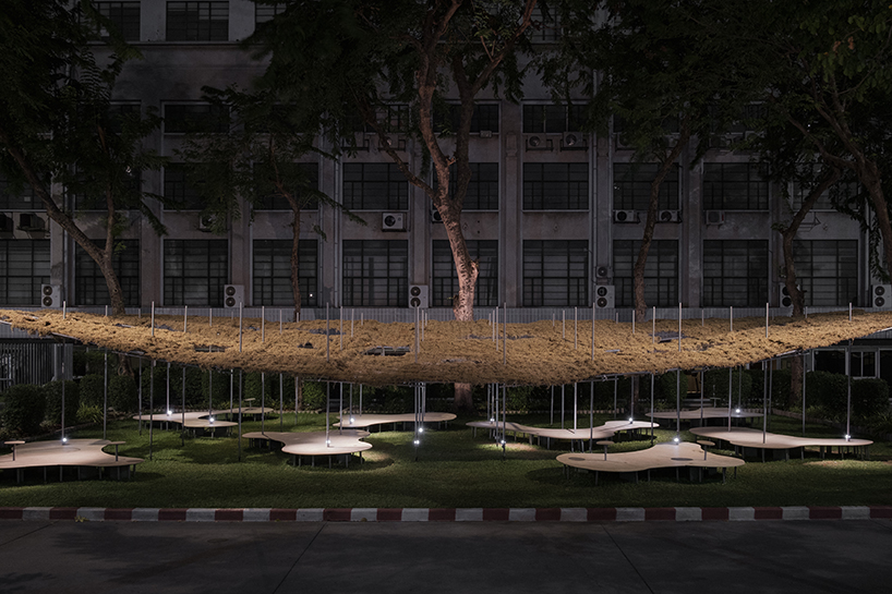 people pavilion's decomposed grass canopy shades over free-form circular seating