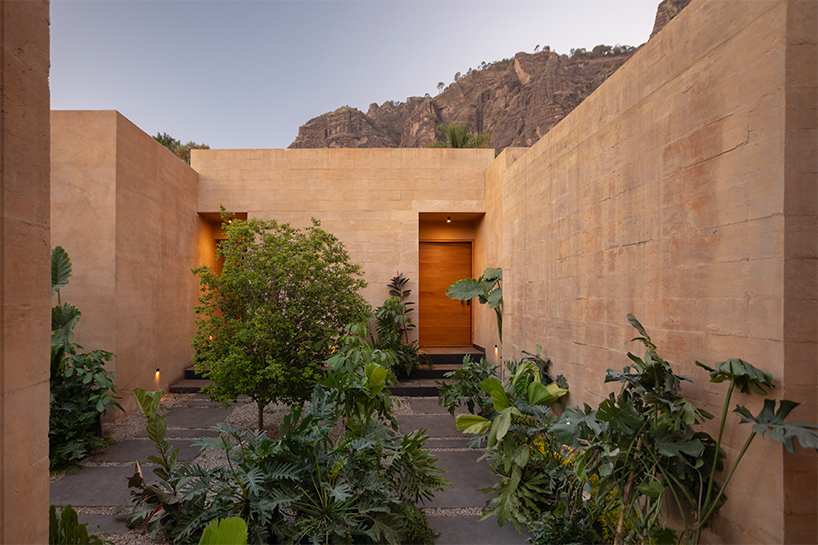 RA! sculpts monolithic house emerging from the rocky tepozteco cliffs in mexico