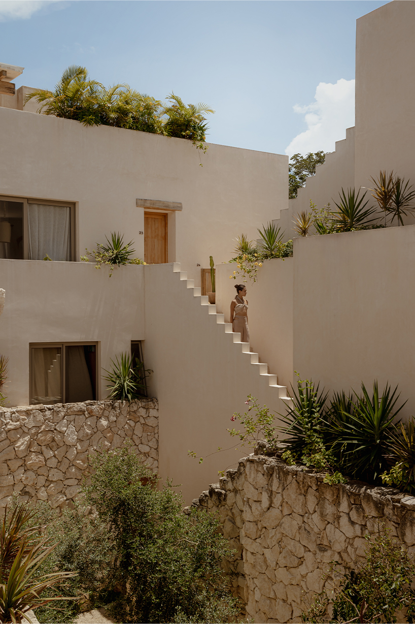 stacked chukum & stone volumes wrapped in green terraces shape RA!'s residences in tulum