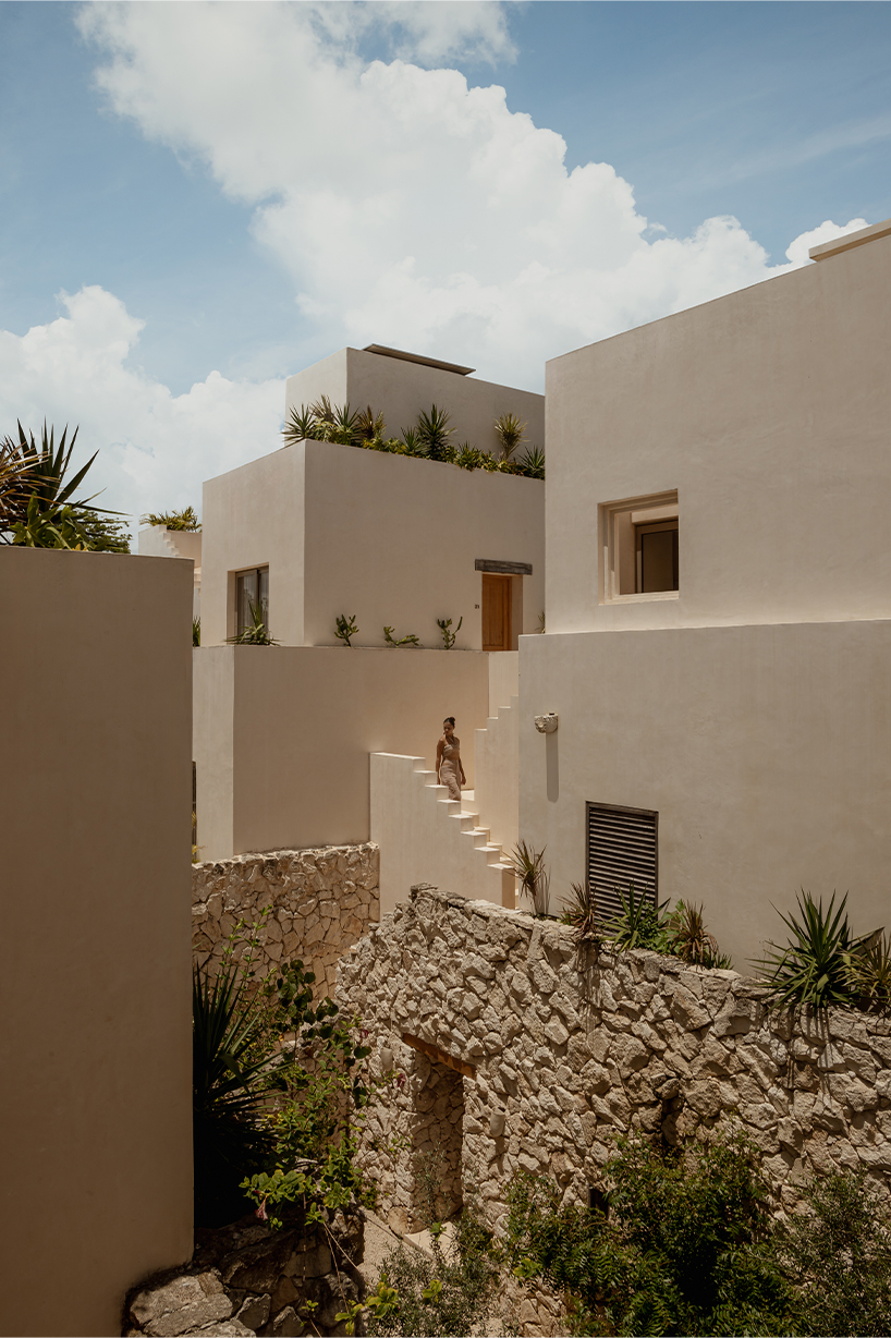 stacked chukum & stone volumes wrapped in green terraces shape RA!'s residences in tulum