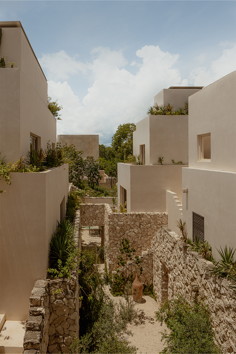 stacked chukum & stone volumes wrapped in green terraces shape RA!'s residences in tulum