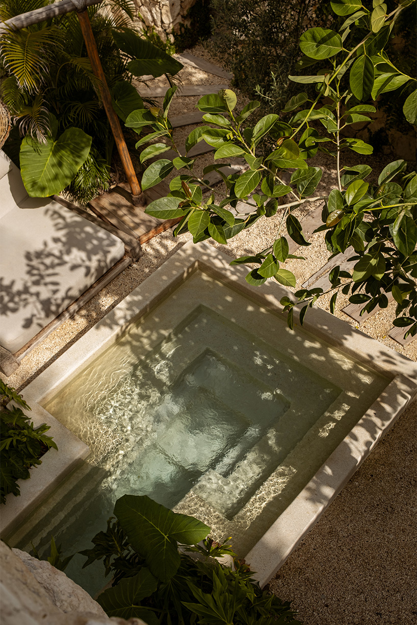 stacked chukum & stone volumes wrapped in green terraces shape RA!'s residences in tulum