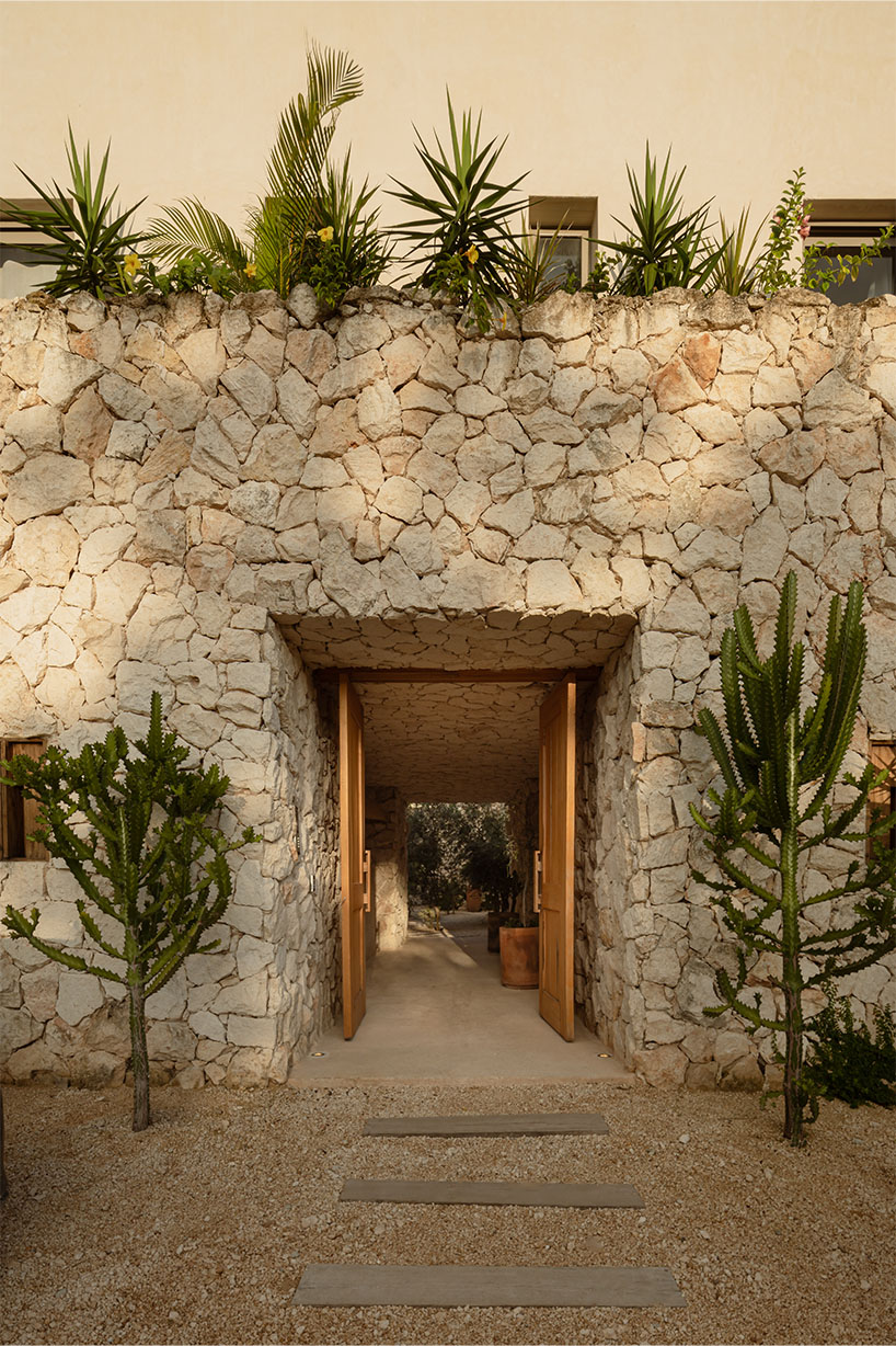 stacked chukum & stone volumes wrapped in green terraces shape RA!'s residences in tulum